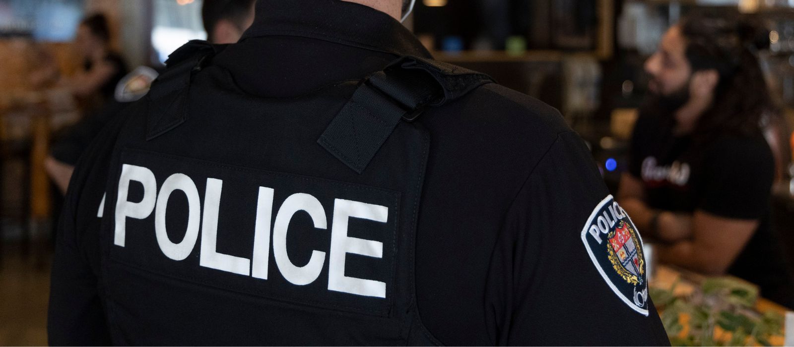 Ottawa Police officer converses with a community resident in a restaurant.