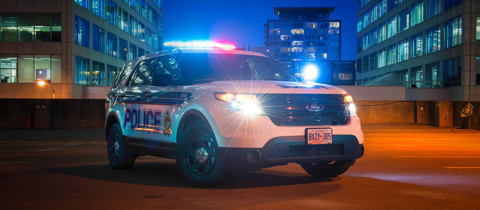 Police cruiser with lights on at night.