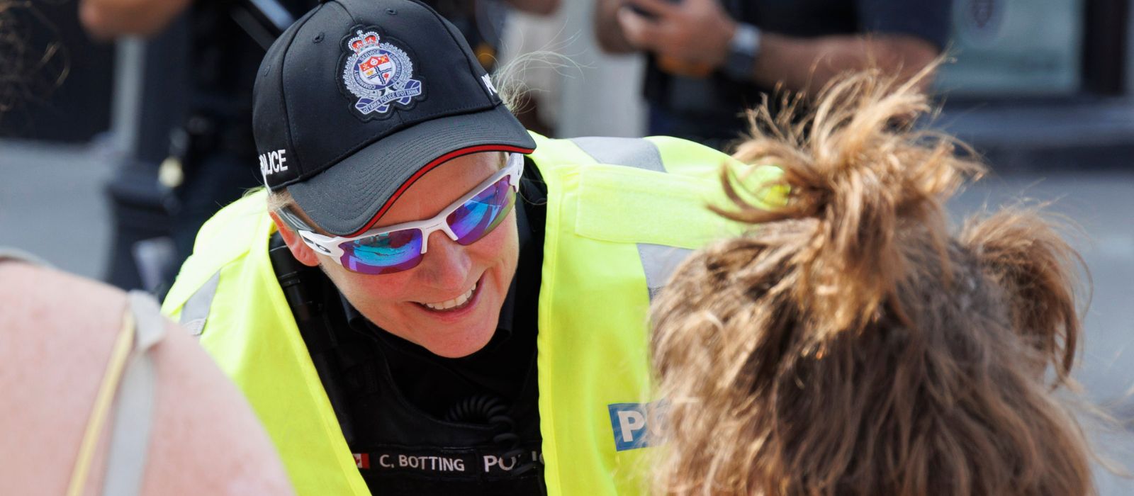 An Ottawa Police officer bends down to talk to a child.