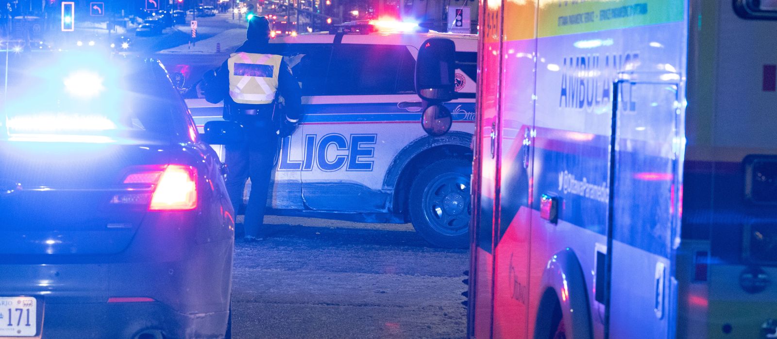 Two police cruisers and an ambulance responding to a call for service.