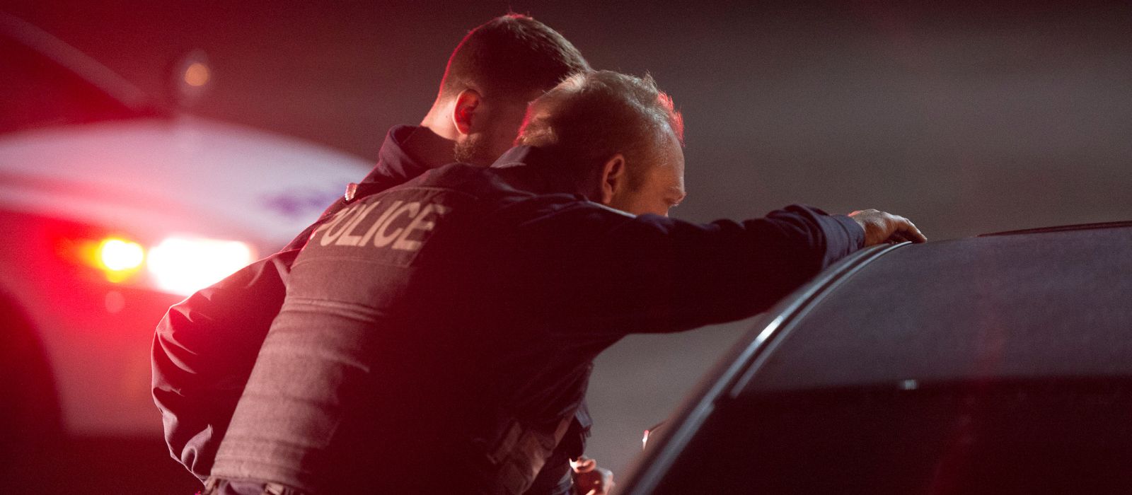 Two Ottawa Police Service members speaking to someone in a vehicle.