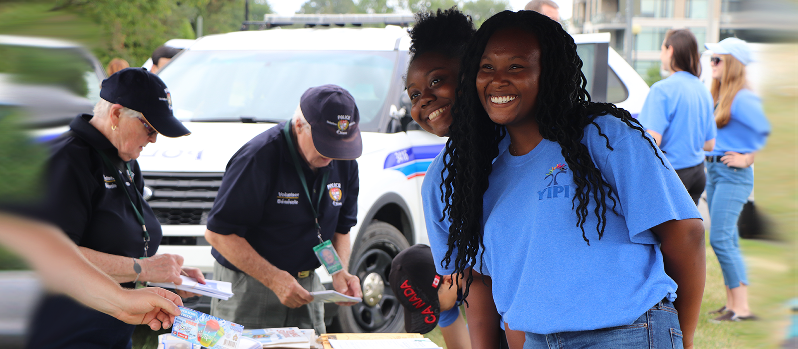 Student volunteers with the Ottawa Police Service help provide residents with information