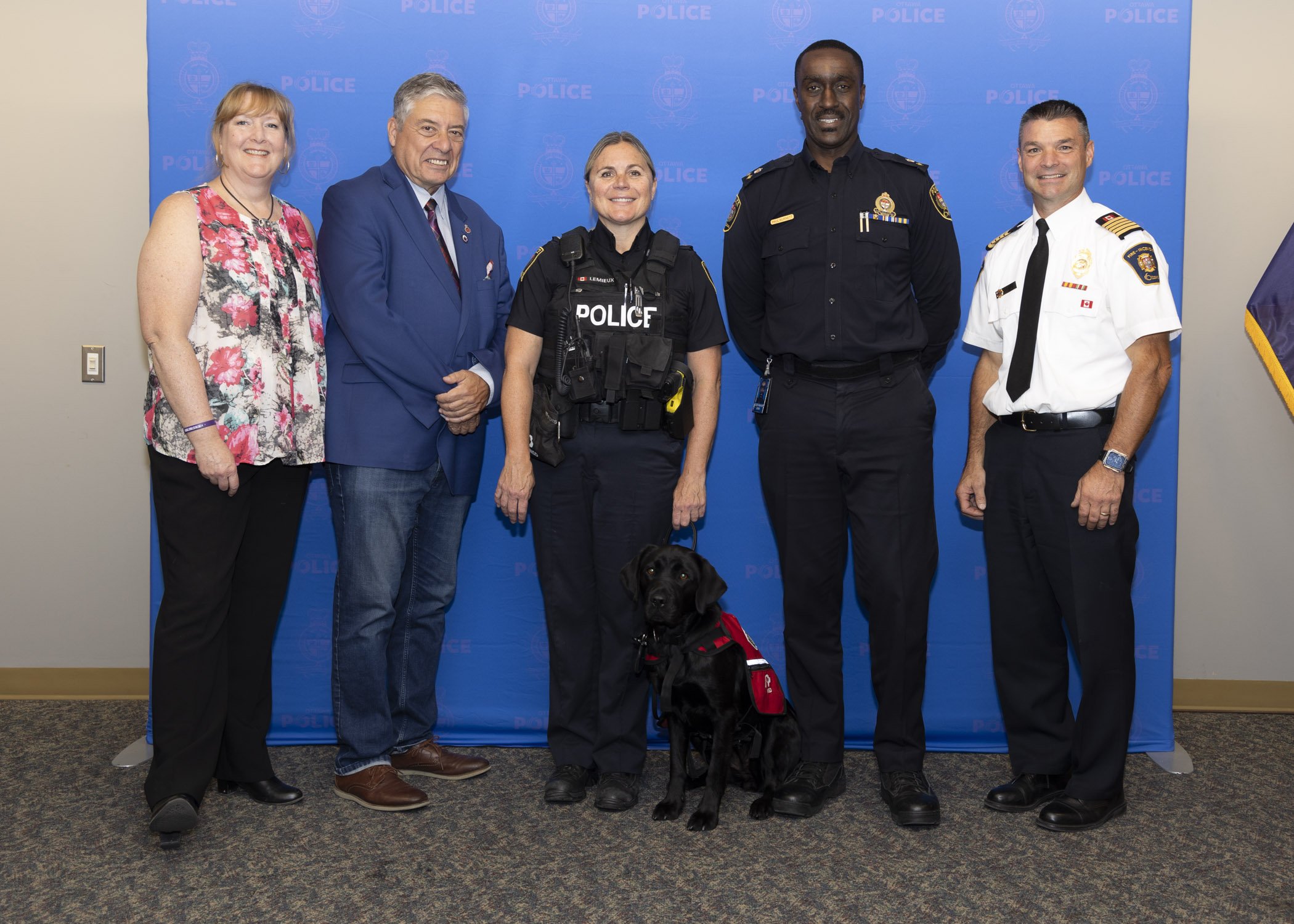Group photo including representatives from Wounded Warriors Canada, National Service Dogs, Ottawa Police Service and Ottawa Fire Services