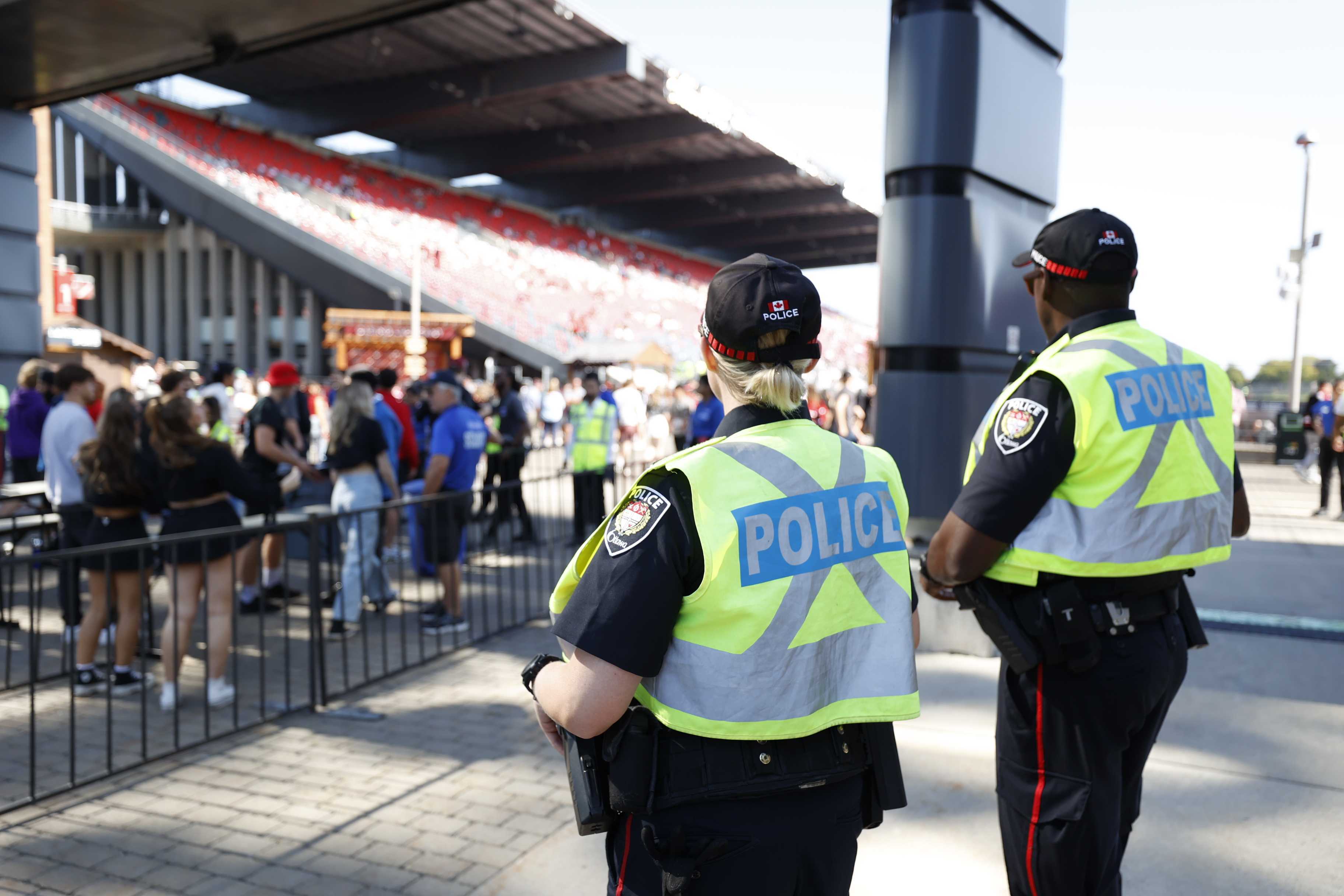 Two police officers overseeing a crowd at the 2023 Panda Game