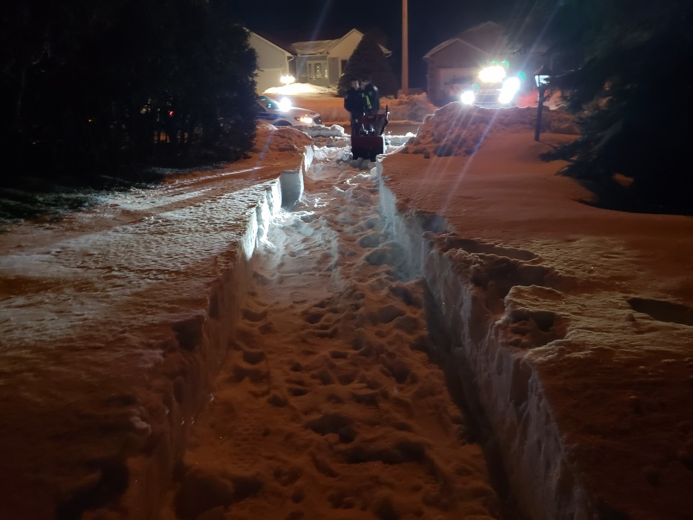 Officers shovel and snow blow driveway for elderly man
