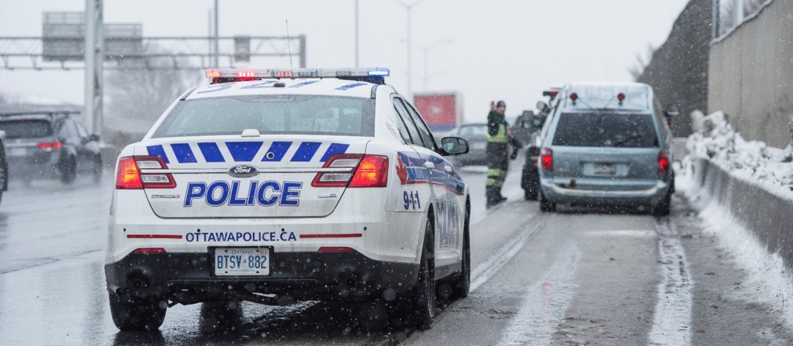 Police attend to a stalled vehicle on the Queensway