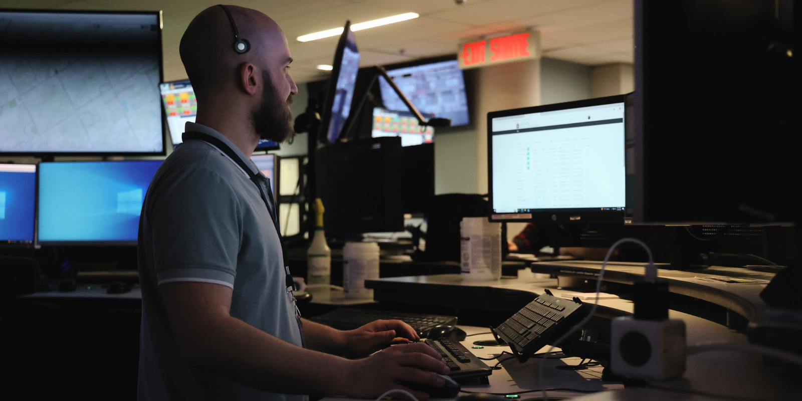 A 911 police communicator looking at several screens