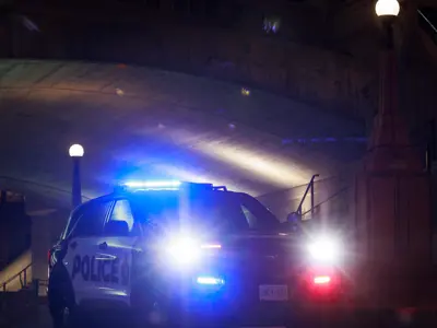 Ottawa Police cruiser at night under a bridge. / Une voiture de police d'Ottawa, de nuit, sous un pont. 