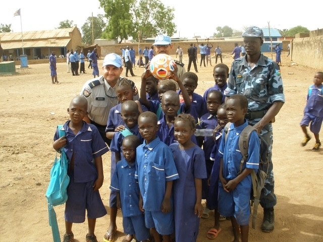 Sgt. Anvari during the mission in Africa with children and a team lead.