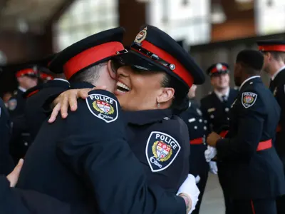 Two officers hugging at an Ottawa Police Service Badge Ceremony