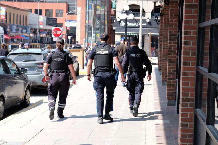 Police officers and a Special Constable walking in downtown Ottawa