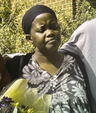 Black female, wearing dark coloured head wrap