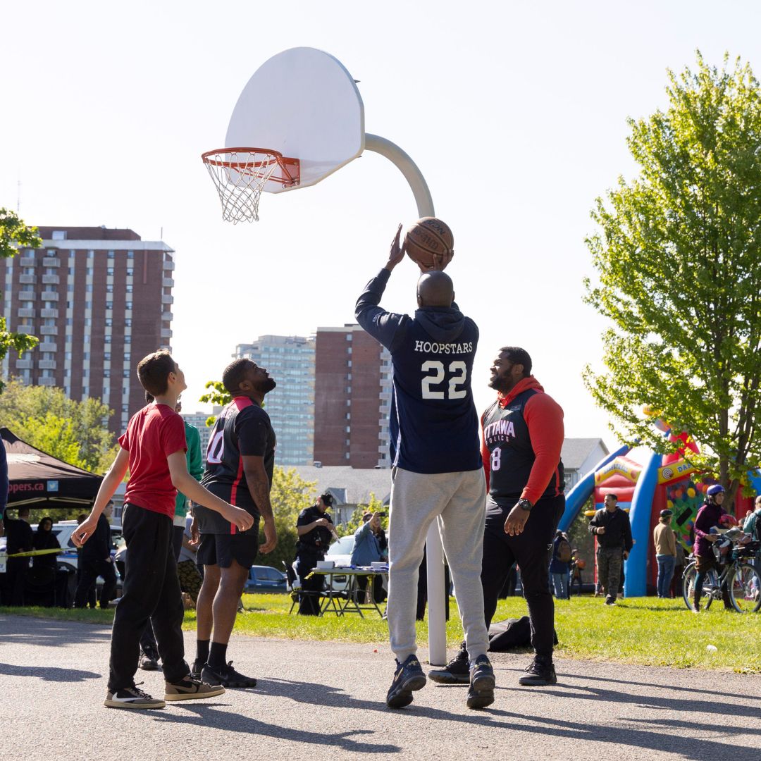 Ottawa Police Hoopstars playing basketball with community members