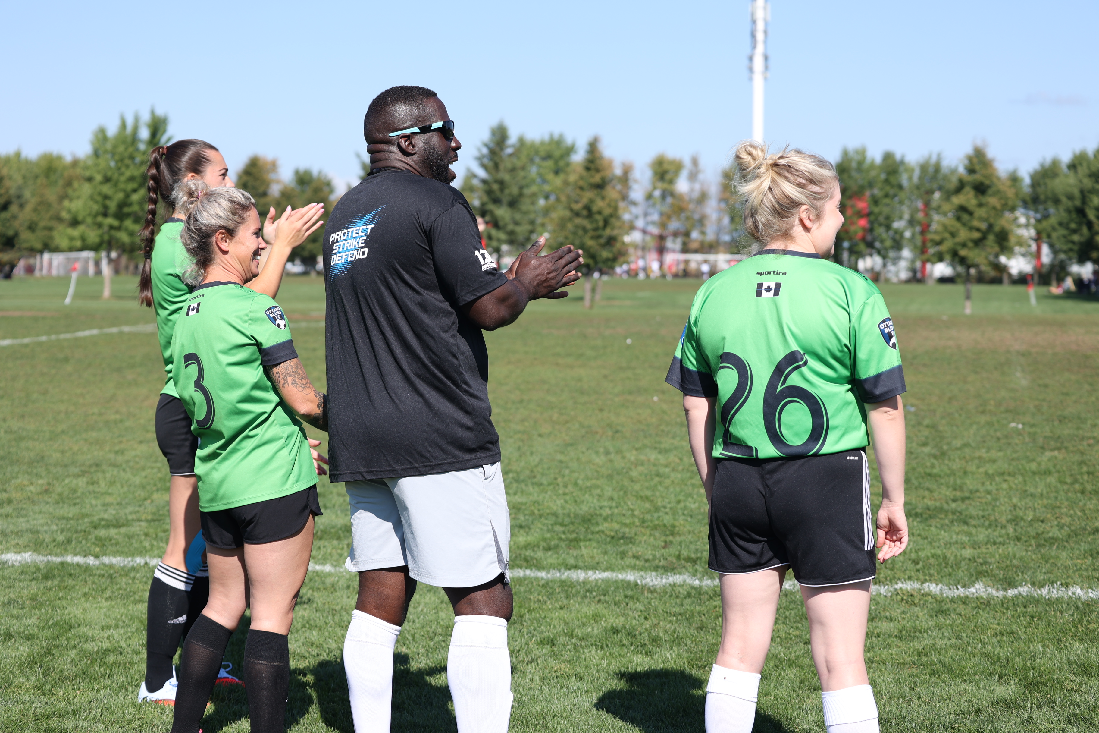 Sgt. Devon Archer and the OPS women's team cheering on their teammates.